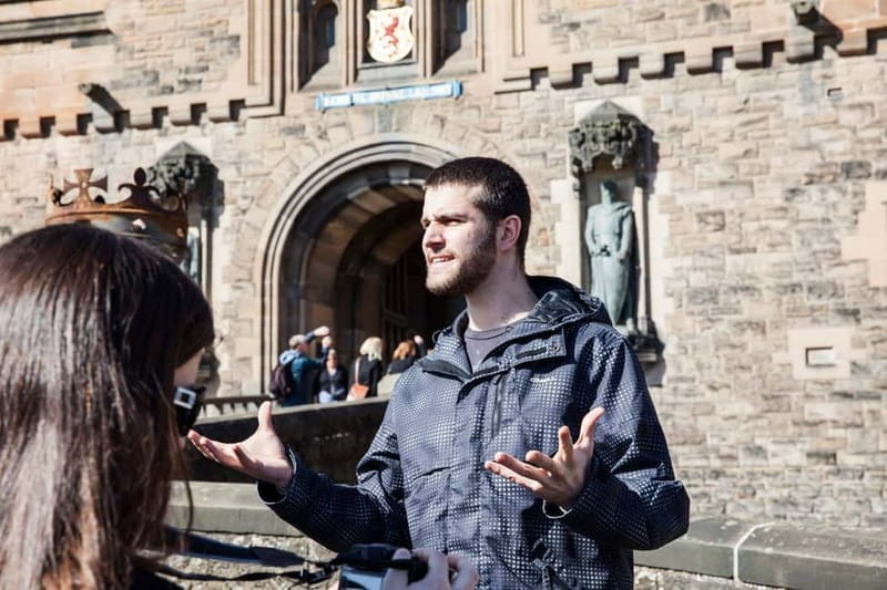 Edinburgh: Edinburgh Castle Guided History Tour with Tickets - Meeting on the Royal Mile: Adam Smith, green-and-white umbrellas, and a short walk up